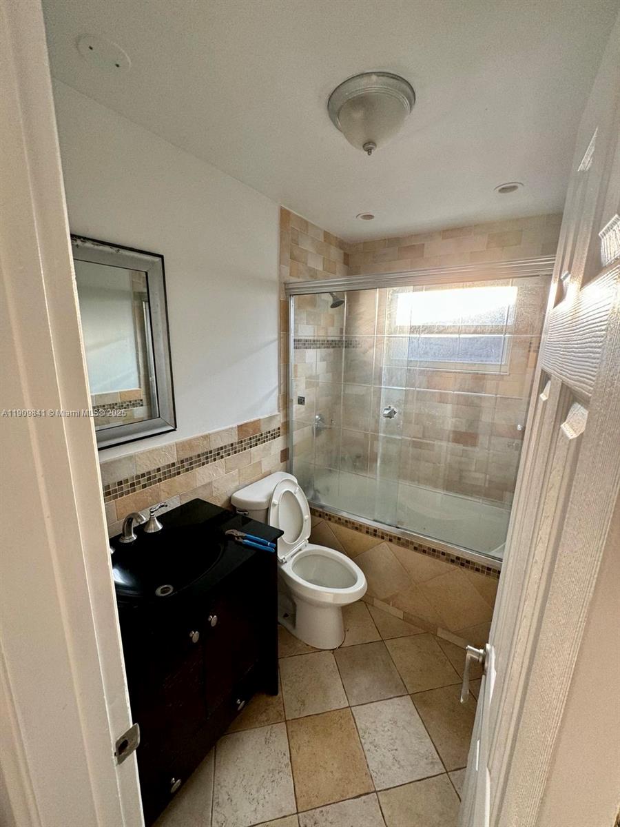 8670 Northwest 28th Place Sunrise, FL 33322 - Photo 7 of 13 a bathroom with a sink and a mirror