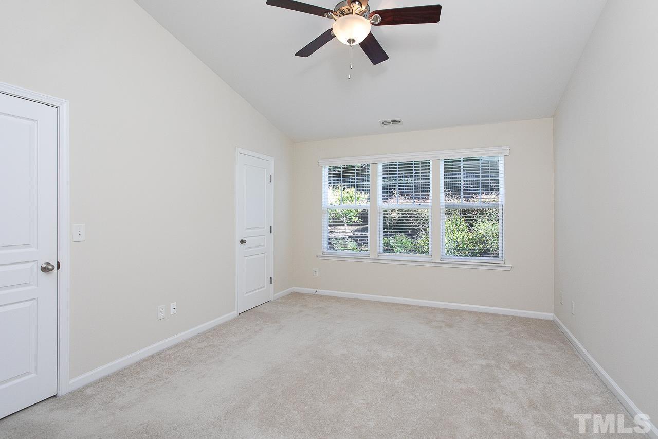 6016 Viking Drive Raleigh, NC 27612 - Photo 10 of 18 an empty room with a window and a ceiling fan