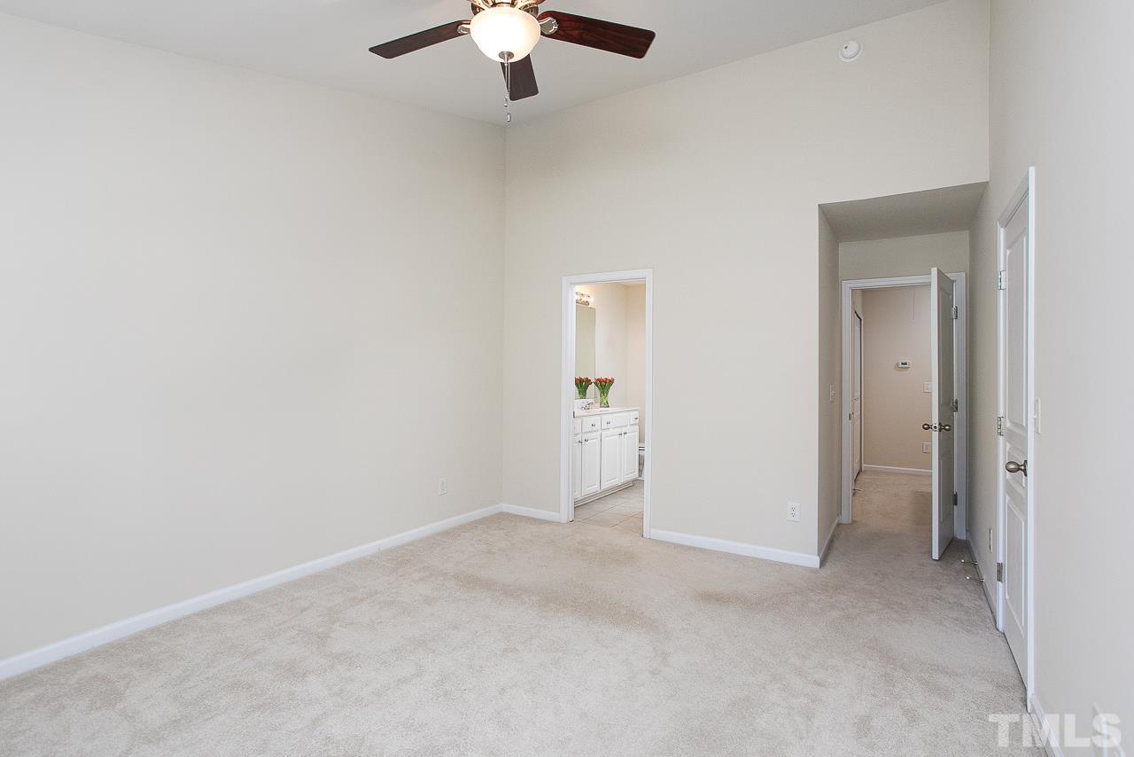 6016 Viking Drive Raleigh, NC 27612 - Photo 11 of 18 an empty room with chandelier fan