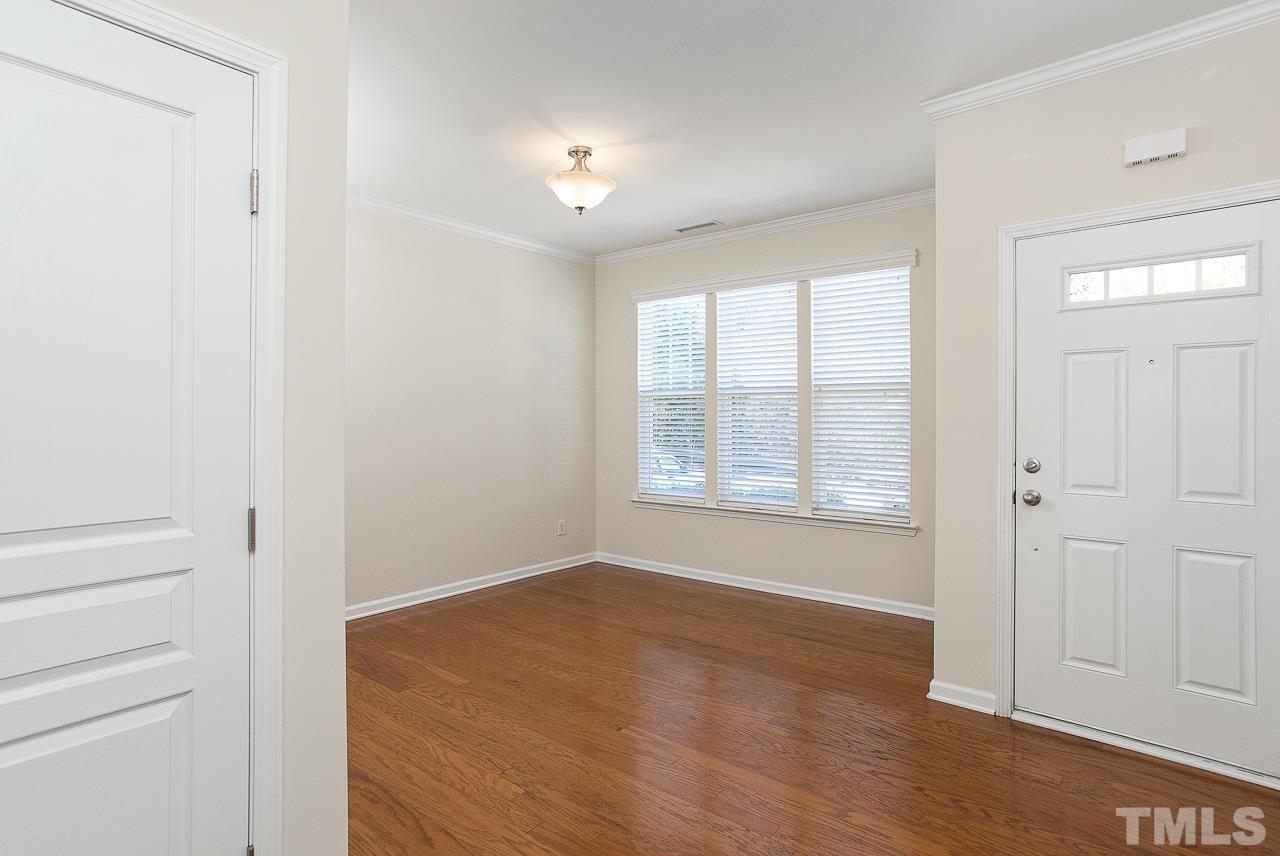 6016 Viking Drive Raleigh, NC 27612 - Photo 6 of 18 a view of an empty room with wooden floor and a window