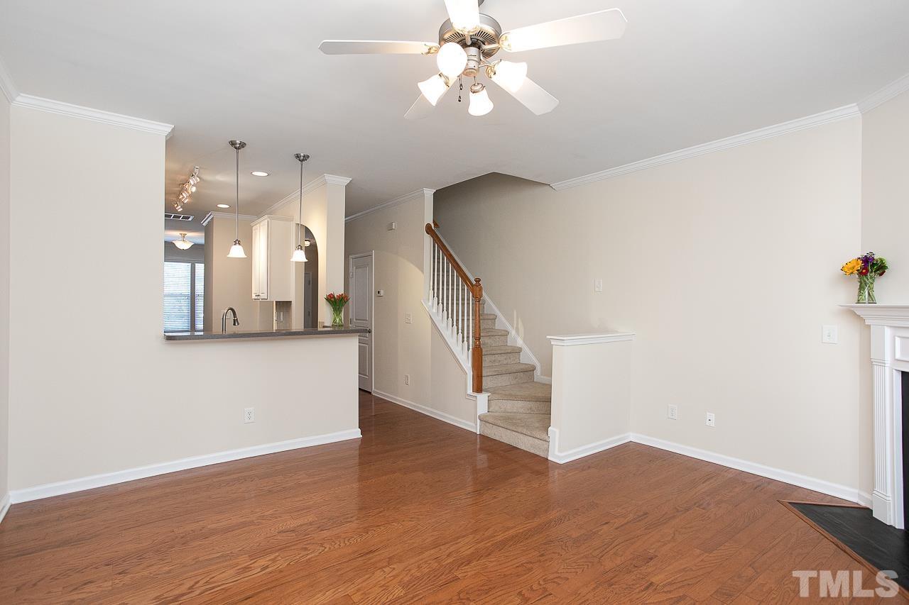 6016 Viking Drive Raleigh, NC 27612 - Photo 18 of 18 a view of a room with wooden floor and ceiling fan