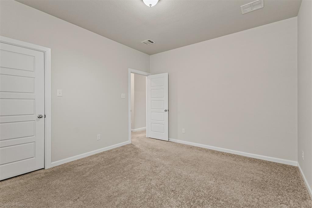 638 Pinehurst Road Red Oak, TX 75154 - Photo 11 of 38 Unfurnished bedroom with baseboards and light carpet