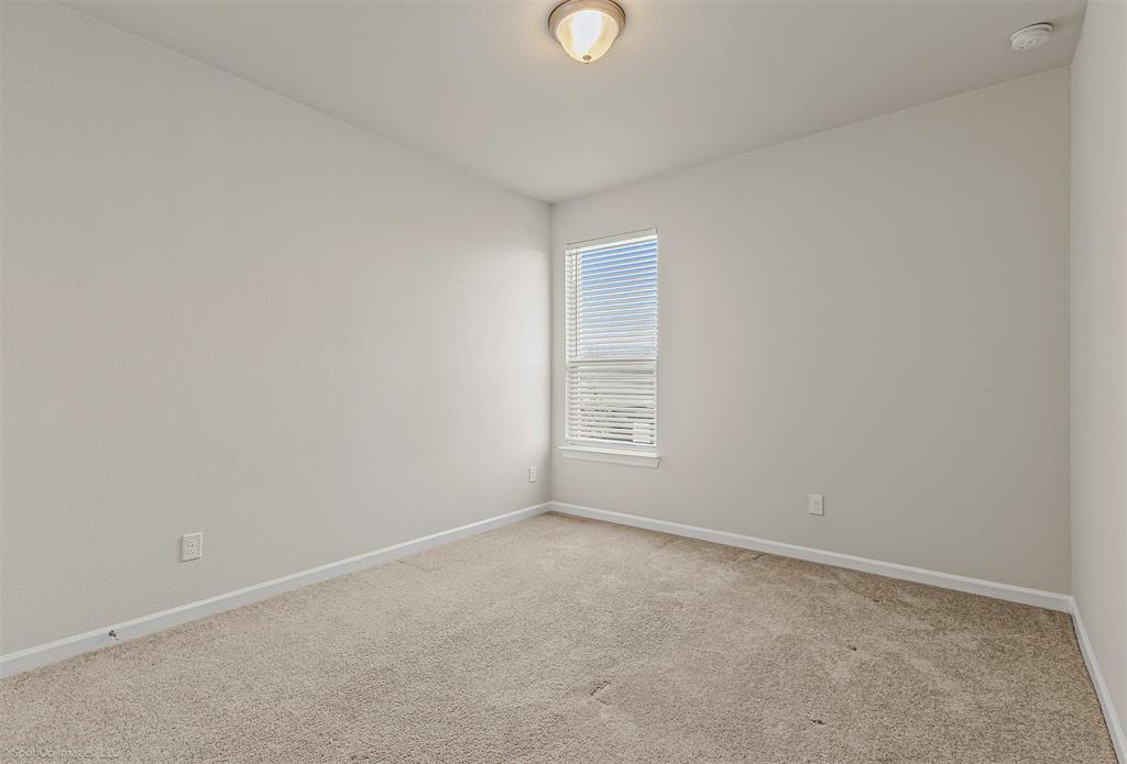 638 Pinehurst Road Red Oak, TX 75154 - Photo 12 of 38 Carpeted empty room featuring baseboards