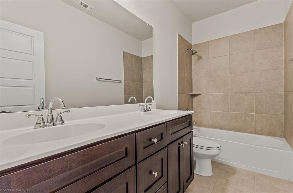 638 Pinehurst Road Red Oak, TX 75154 - Photo 14 of 38 Full bath with double vanity, light tile patterned flooring, and bathing tub / shower combination