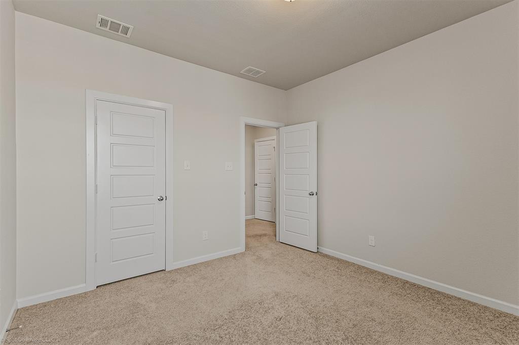638 Pinehurst Road Red Oak, TX 75154 - Photo 16 of 38 Unfurnished bedroom featuring baseboards and light colored carpet