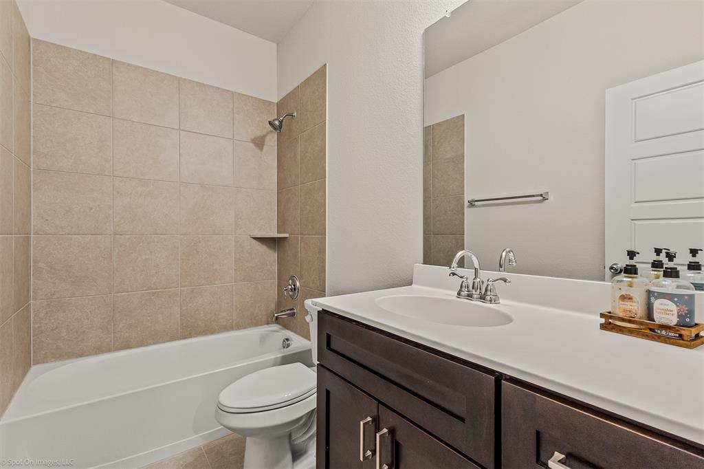 638 Pinehurst Road Red Oak, TX 75154 - Photo 17 of 38 Bathroom featuring vanity, shower / bathtub combination, and light tile patterned floors