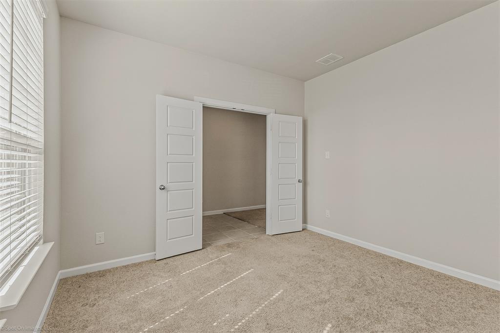 638 Pinehurst Road Red Oak, TX 75154 - Photo 19 of 38 Unfurnished bedroom featuring multiple windows and light carpet