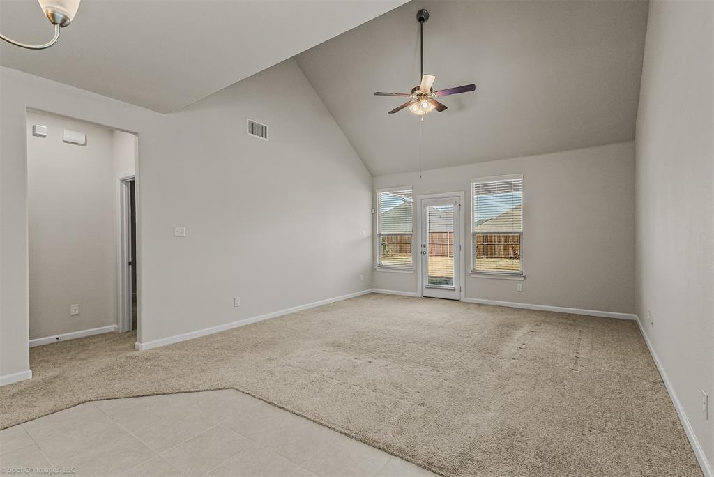 638 Pinehurst Road Red Oak, TX 75154 - Photo 29 of 38 Spare room with light carpet, a ceiling fan, vaulted ceiling, and light tile patterned flooring