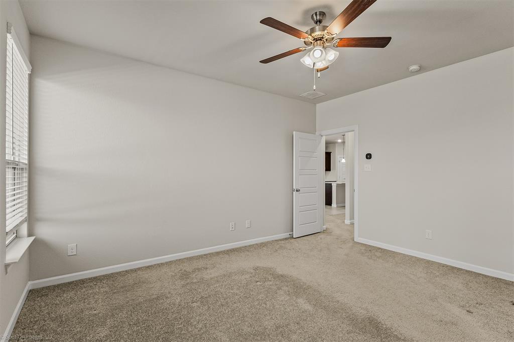 638 Pinehurst Road Red Oak, TX 75154 - Photo 31 of 38 Carpeted spare room with baseboards and ceiling fan