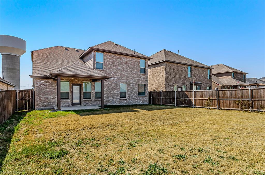 638 Pinehurst Road Red Oak, TX 75154 - Photo 6 of 38 Back of house featuring brick siding, a patio area, a shingled roof, and a fenced backyard