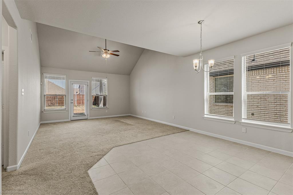 638 Pinehurst Road Red Oak, TX 75154 - Photo 10 of 38 Unfurnished room featuring light colored carpet, ceiling fan, a chandelier, vaulted ceiling, and light tile patterned floors