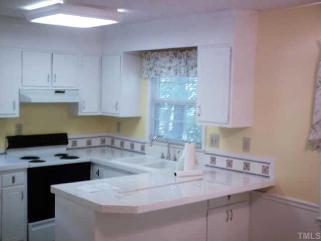 5901 Shamrock Road Durham, NC 27713 - Photo 3 of 6 Nicely decorated, light & airy eat-in kitchen with tile countertops