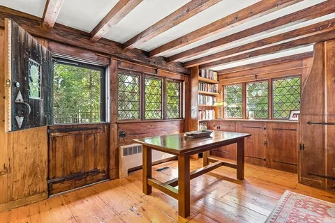 a view of a workspace with furniture and window