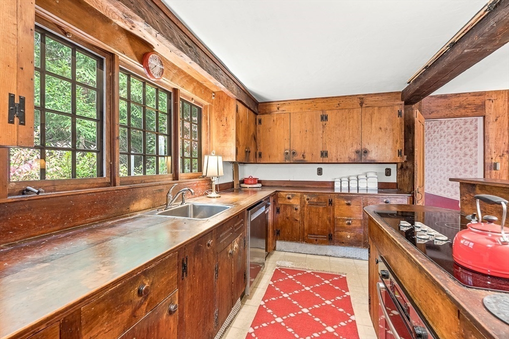 5 Wood Lane Winchester, MA 01890 - Photo 16 of 42 a kitchen with stainless steel appliances granite countertop a sink and a stove