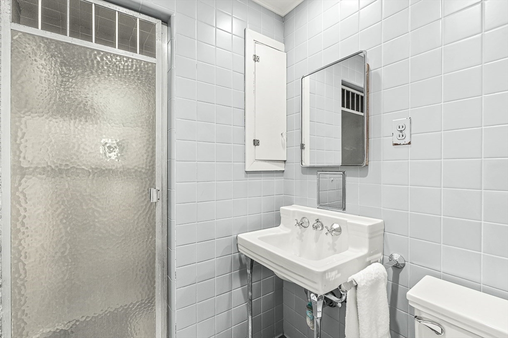 5 Wood Lane Winchester, MA 01890 - Photo 29 of 42 a bathroom with a sink shower and a mirror