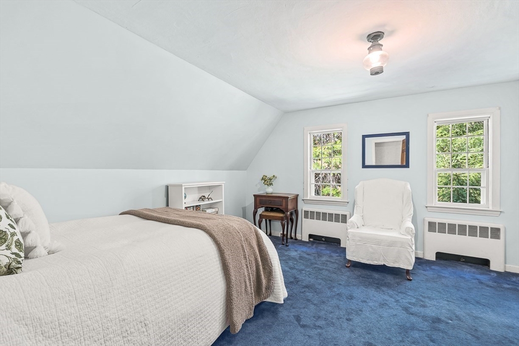 5 Wood Lane Winchester, MA 01890 - Photo 33 of 42 a spacious bedroom with a bed next to a window with a flat screen tv