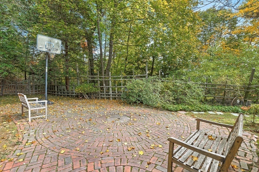 5 Wood Lane Winchester, MA 01890 - Photo 35 of 42 a view of a chair and table in the backyard