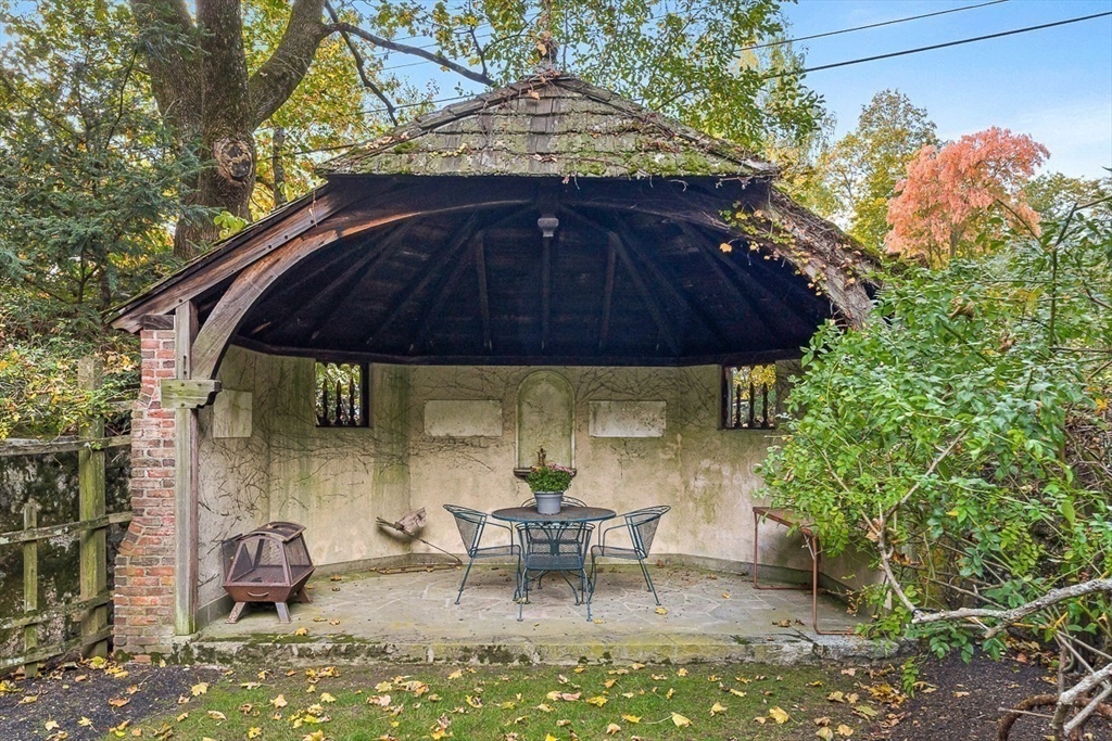 5 Wood Lane Winchester, MA 01890 - Photo 5 of 42 a view of backyard with table and chairs under an umbrella