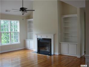 112 Rushing Water Lane Troutman, NC 28166 - Photo 6 of 16 an empty room with windows and a fireplace