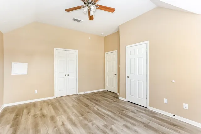 a view of a livingroom with a ceiling fan and window