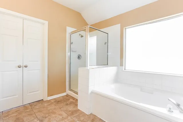 a bathroom with a bathtub and a shower