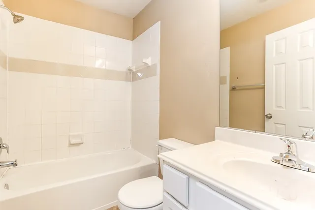 a bathroom with a sink a toilet and bathtub