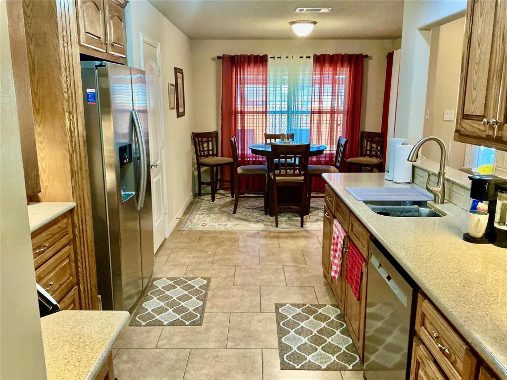 312 McAfee Street Mabank, TX 75147 - Photo 20 of 40 a kitchen with stainless steel appliances granite countertop sink stove and cabinets