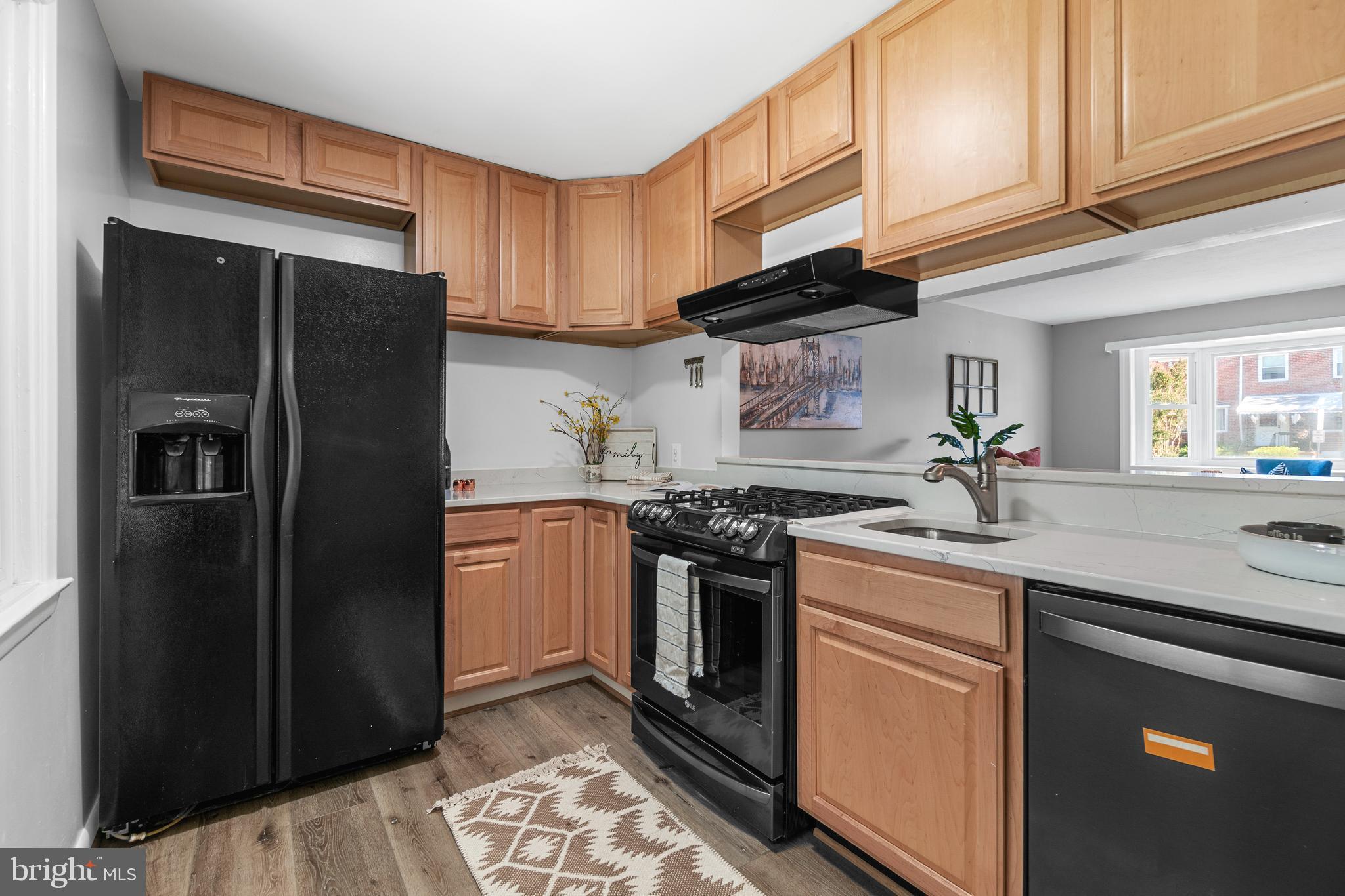 1618 Riverwood Road Baltimore, MD 21221 - Photo 6 of 26 a kitchen with stainless steel appliances granite countertop a refrigerator stove and sink