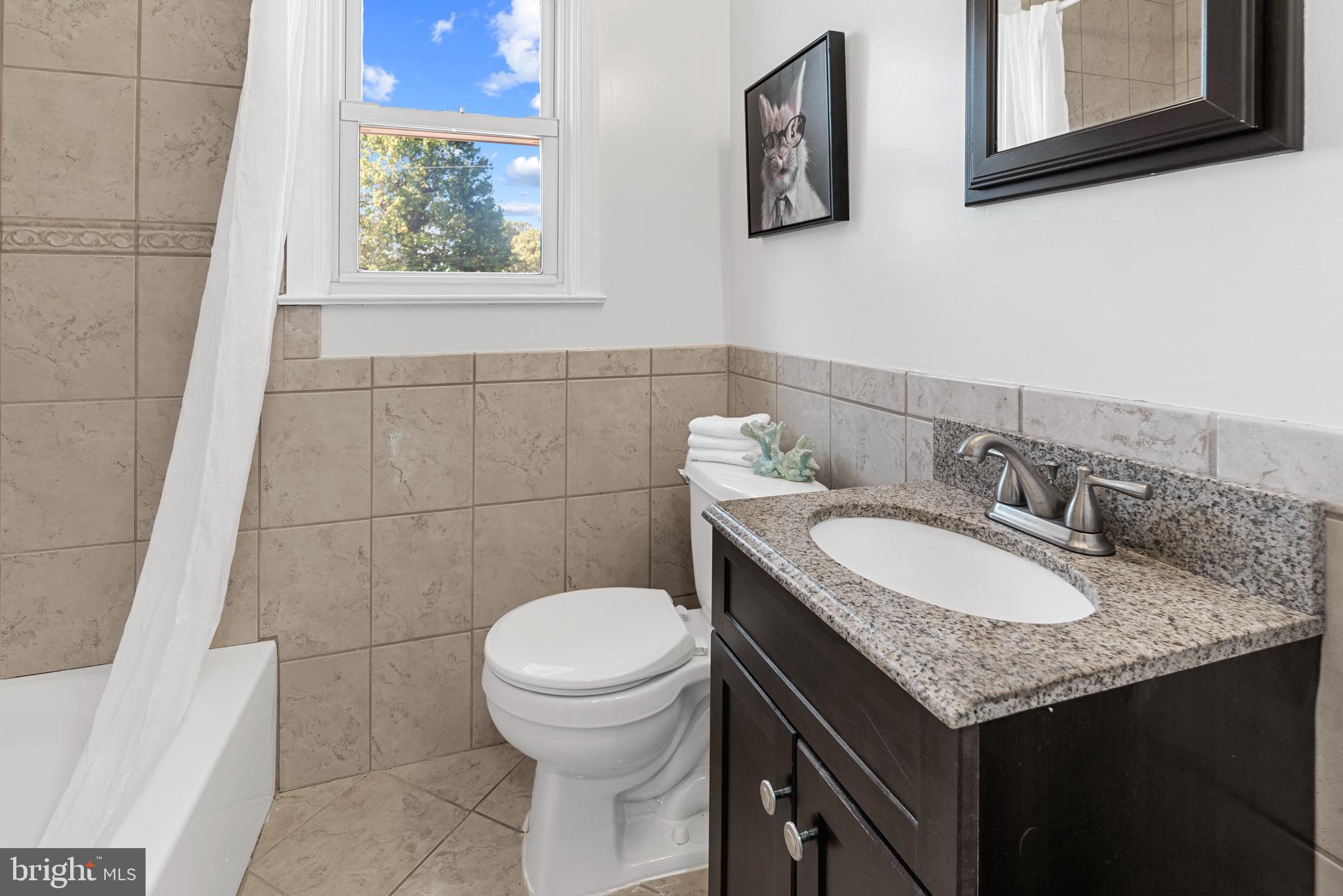 1618 Riverwood Road Baltimore, MD 21221 - Photo 10 of 26 a bathroom with a granite countertop sink and a toilet