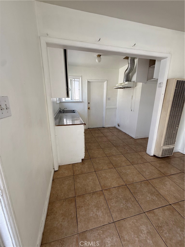 1946 Bryce Road South El Monte, CA 91733 - Photo 3 of 5 a kitchen with a sink a refrigerator and cabinets