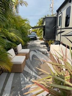 55 Boca Chica Road, Unit 47 Key West, FL 33040 - Photo 15 of 18 a view of a patio with couches chairs and a potted plant