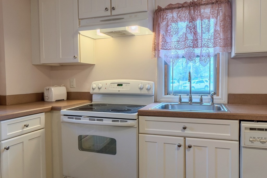 201-203 Stone Street Clinton, MA 01510 - Photo 12 of 42 a kitchen with appliances cabinets and a window