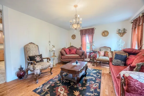 a living room with furniture and a chandelier