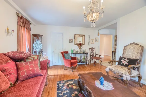 a living room with furniture chandelier and a chandelier