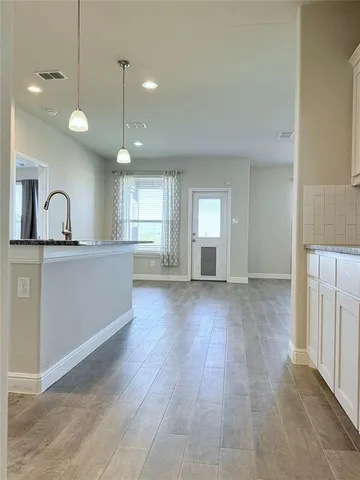 a view of a kitchen with a sink and cabinets