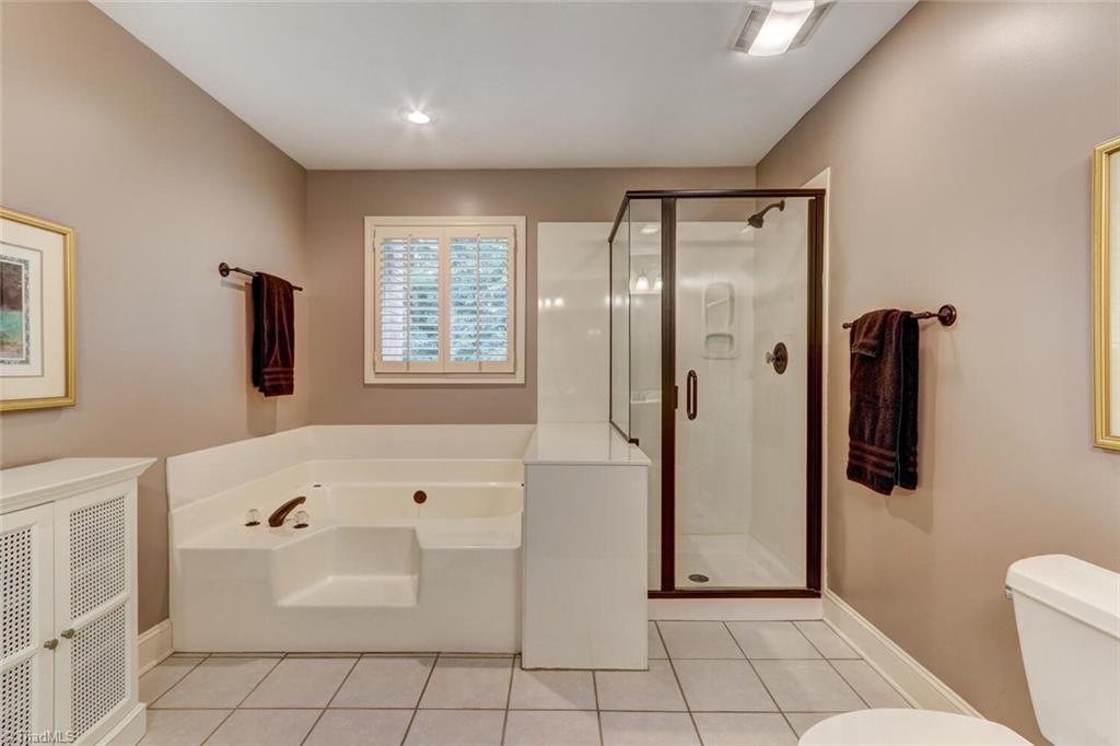 8200 Brittains Field Road Oak Ridge, NC 27310 - Photo 24 of 38 PRIMARY BATHROOOM WITH TUB AND SEPARATE SHOWER