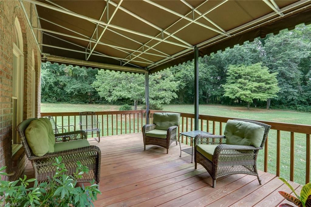 8200 Brittains Field Road Oak Ridge, NC 27310 - Photo 32 of 38 REAR DECK IS COVERED WITH AN AWNING AND HAS A ROLLER SHADE AS WELL
