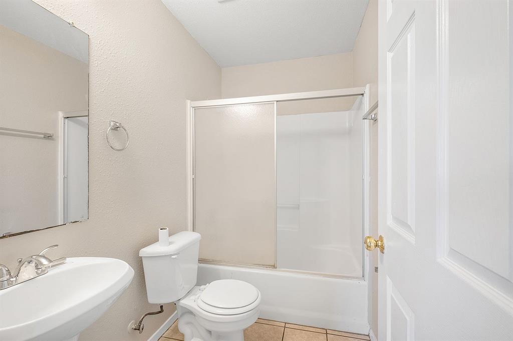 2214 Katy Lane, Unit A Georgetown, TX 78626 - Photo 12 of 15 a white toilet sitting next to a bathroom sink