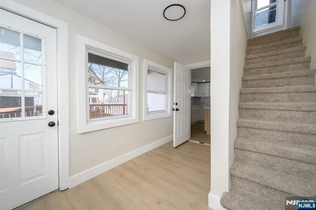 a view of an entryway with wooden floor and windows