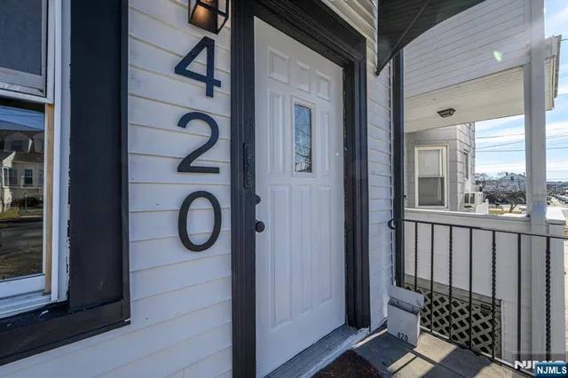 a view of a balcony with wooden floor and door
