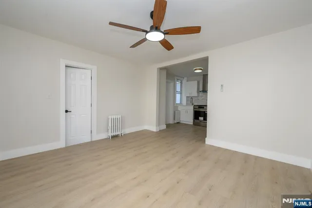 a view of an empty room with a ceiling fan
