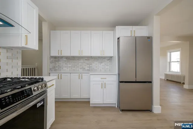 a kitchen with cabinets and white appliances