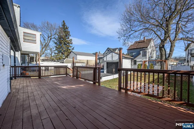 a view of a house with a wooden deck