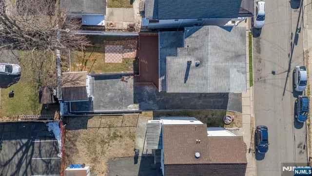 an aerial view of house with yard and mountain view in back