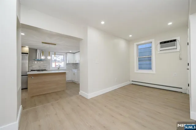 a large kitchen with a refrigerator and a stove top oven