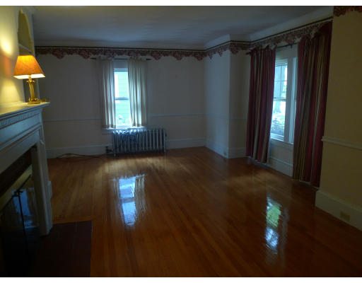 53 Rockland Street Springfield, MA 01118 - Photo 3 of 17 a view of an empty room with wooden floor and a window