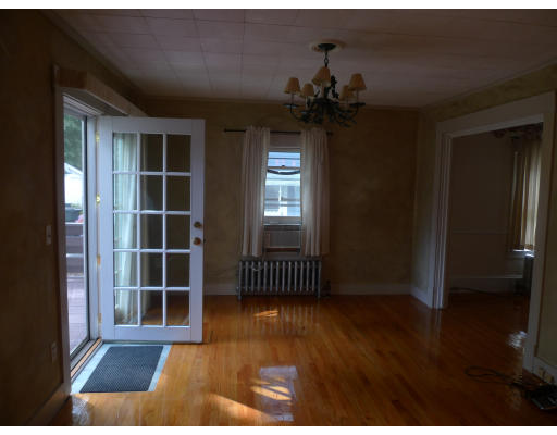 53 Rockland Street Springfield, MA 01118 - Photo 4 of 17 a view of empty room with wooden floor and fan