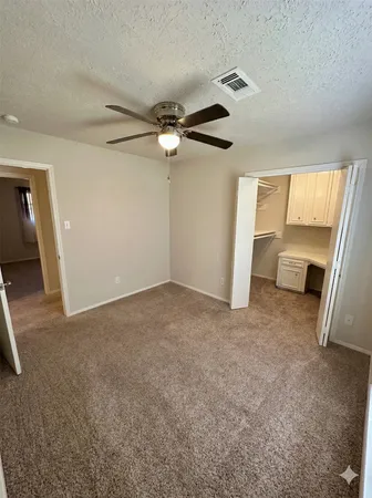 a view of a livingroom with a ceiling fan and window