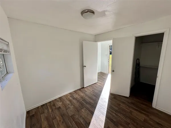 a view of hallway with wooden floor and staircase