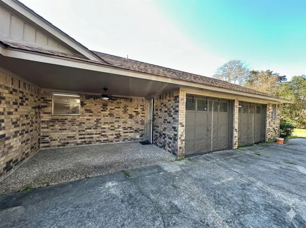 a view of a house with a large tree